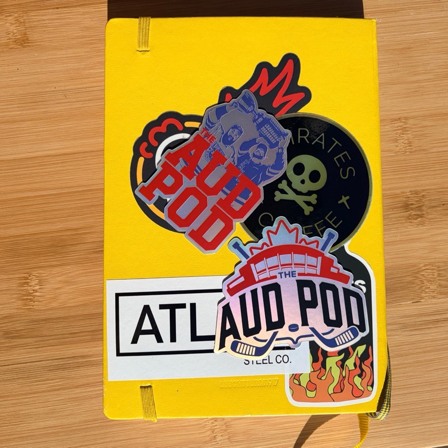 AudPod holo stickers on a notebook